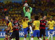 Germany's Manuel Neuer (C, top) makes a save during a Brazil corner kick in their 2014 World Cup semi-finals at the Mineirao stadium in Belo Horizonte July 8, 2014. REUTERS/Eddie Keogh