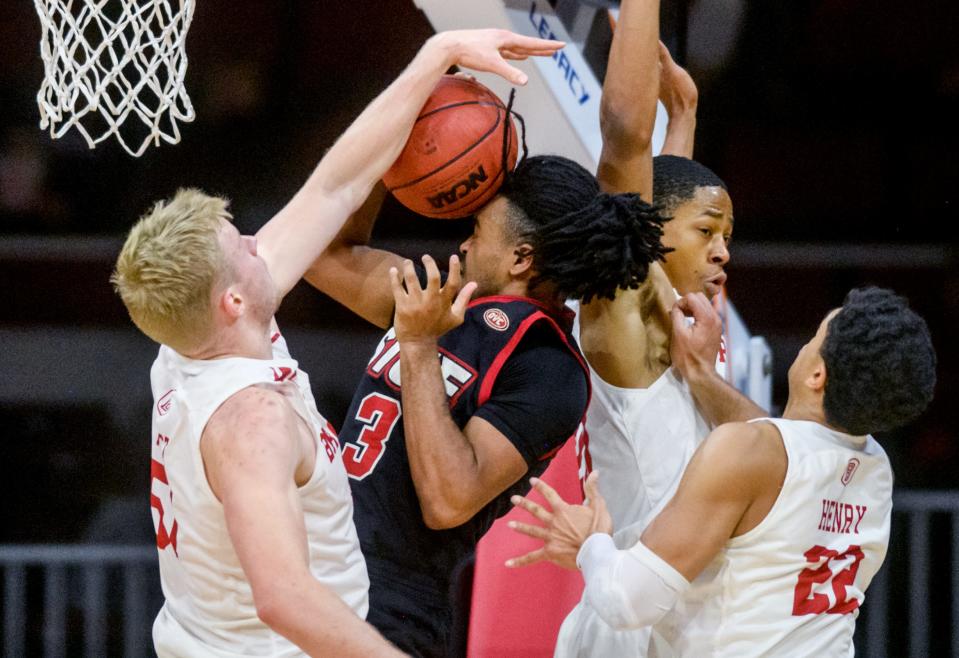 Bradley's Rienk Mast, left, stuffs SIU-Edwardsville's Ray'Sean Taylor (30) as teammates Ja'Shon Henry (22) and Jayson Kent defend in the first half Saturday, Dec. 4, 2021 at Carver Arena. The Braves defeated the Cougars 80-55.