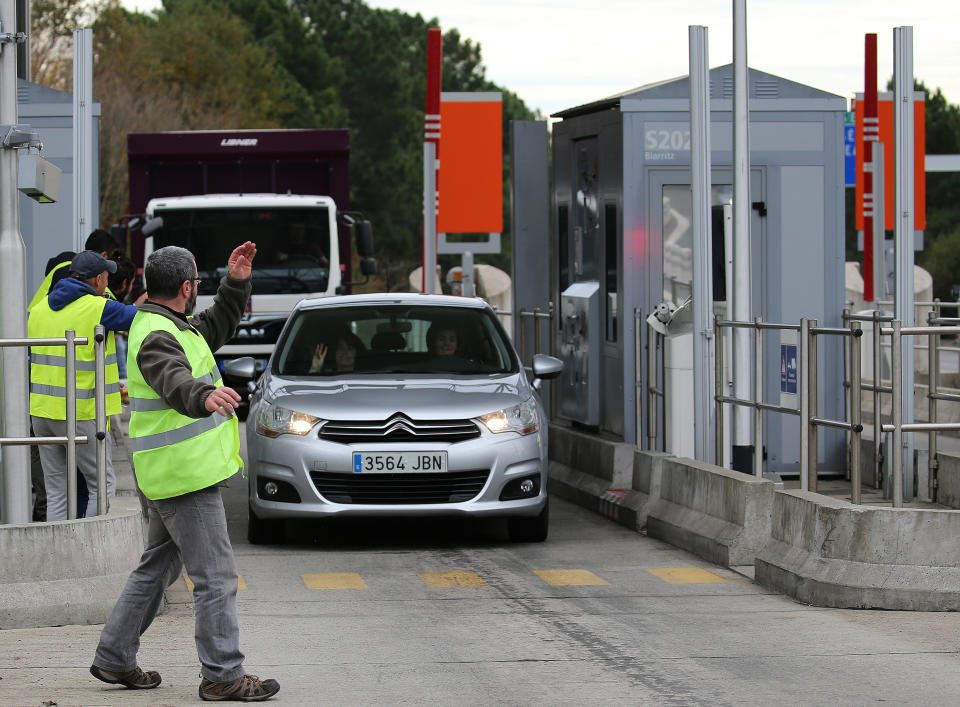 Demonstrators open the toll gates on motorway near Biarritz, southwestern France, Monday, Dec.3, 2018. French Prime Minister Edouard Philippe is holding crisis talks with representatives of major political parties in the wake of violent anti-government protests that have rocked Paris. (AP Photo/Bob Edme)