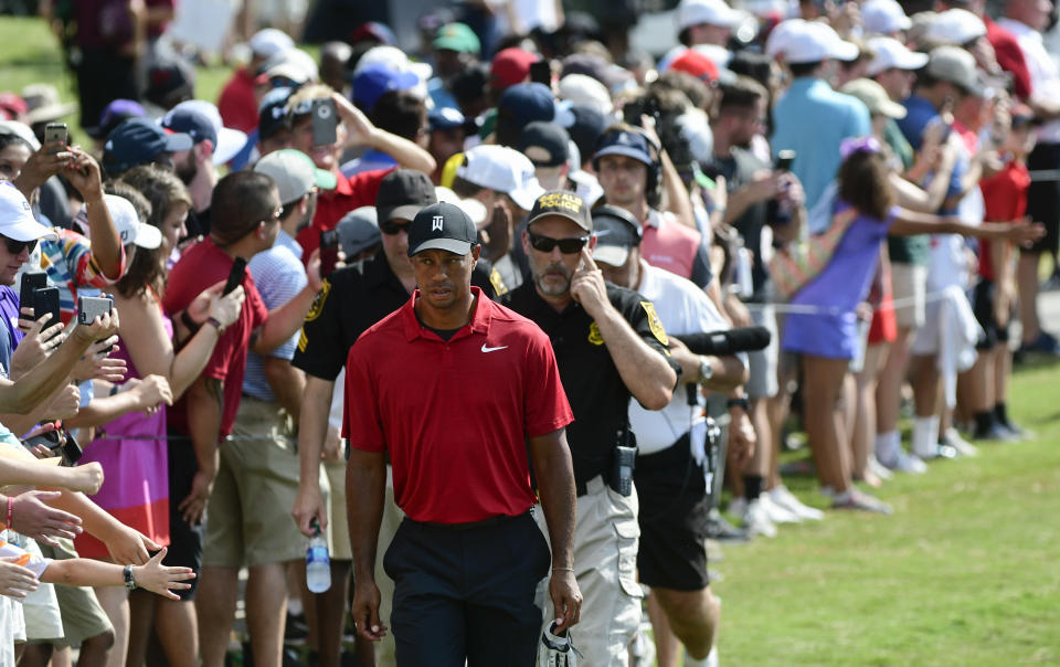 Tiger Woods, foreground, approaches the ninth hole during the final round of the Tour Championship golf tournament Sunday, Sept. 23, 2018, in Atlanta. (AP Photo/John Amis)