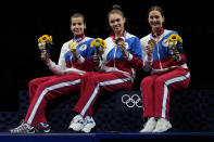 Gold medalists Russian Olympic committee Sabre team celebrate on the podium during the medal ceremony for the women's Sabre team final medal competition at the 2020 Summer Olympics, Saturday, July 31, 2021, in Chiba, Japan. (AP Photo/Hassan Ammar)