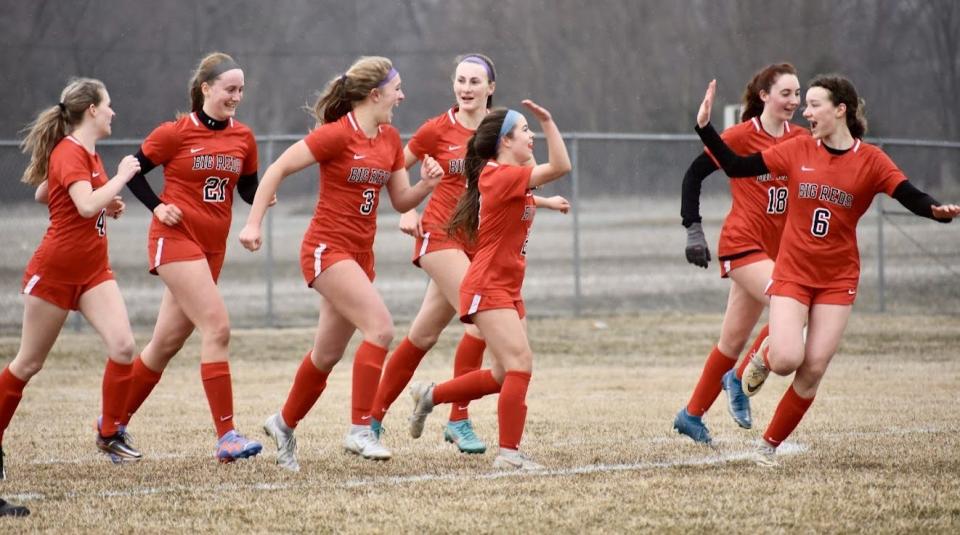 Leah Mazei (center) celebrates with her Milan teammates after scoring one of her four goals during an 11-0 win over Ida Wednesday.