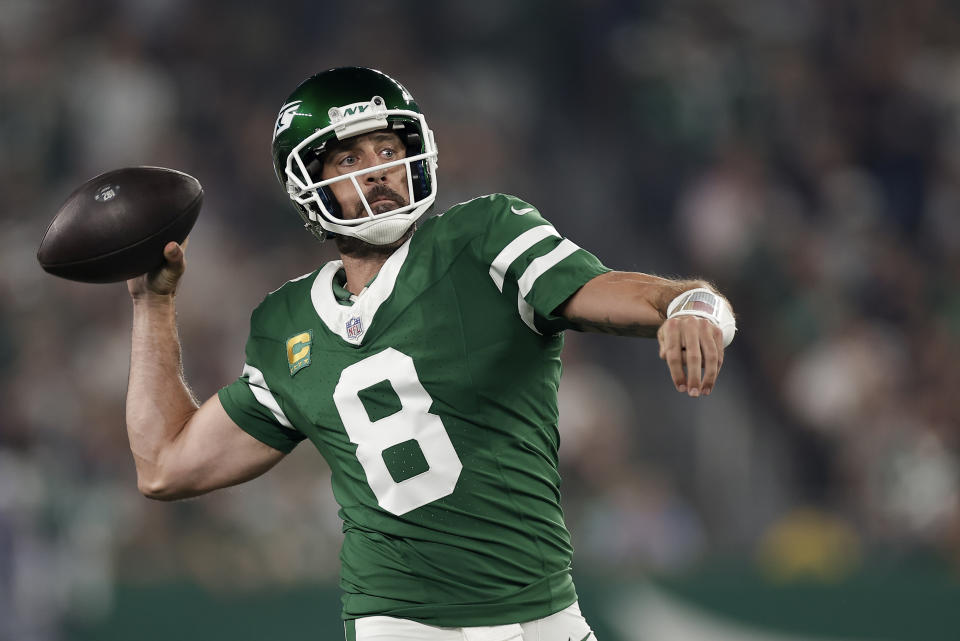 New York Jets quarterback Aaron Rodgers (8) passes against the New England Patriots during the first quarter of an NFL football game, Thursday, Sept. 19, 2024, in East Rutherford, N.J. (AP Photo/Adam Hunger)