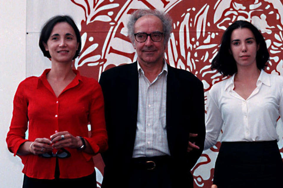 FILE - From left, actor Berangue Allaux, director Jean-Luc Godard, actress Madaleine Assas pose at the unveiling of the movie "For Ever Mozart" in Venice Thursday, Sept. 5 1996. Director Jean-Luc Godard, an icon of French New Wave film who revolutionized popular 1960s cinema, has died, according to French media. He was 91. Born into a wealthy French-Swiss family on Dec. 3, 1930, in Paris, the ingenious "enfant terrible" stood for years as one of the world's most vital and provocative directors in Europe and beyond — beginning in 1960 with his debut feature "Breathless." (AP Photo, File)