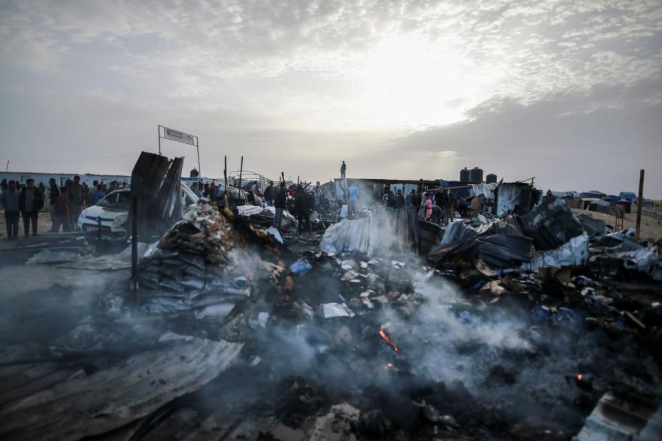 Palestinians look at the destruction after an Israeli strike where displaced people were staying in Rafah, Gaza Strip. (Associated Press)