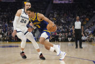 Golden State Warriors guard Jordan Poole, right, tries to get past Memphis Grizzlies forward Dillon Brooks during the first half of an NBA basketball game in San Francisco, Wednesday, Jan. 25, 2023. (AP Photo/Godofredo A. Vásquez)