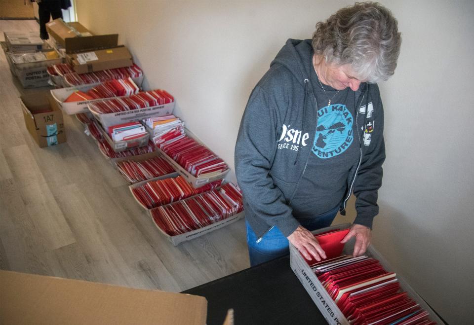 Mary Huston sorts through some of cards that her father, 104-year-old retired Marine Major Bill White, has received for Valentine's Day.