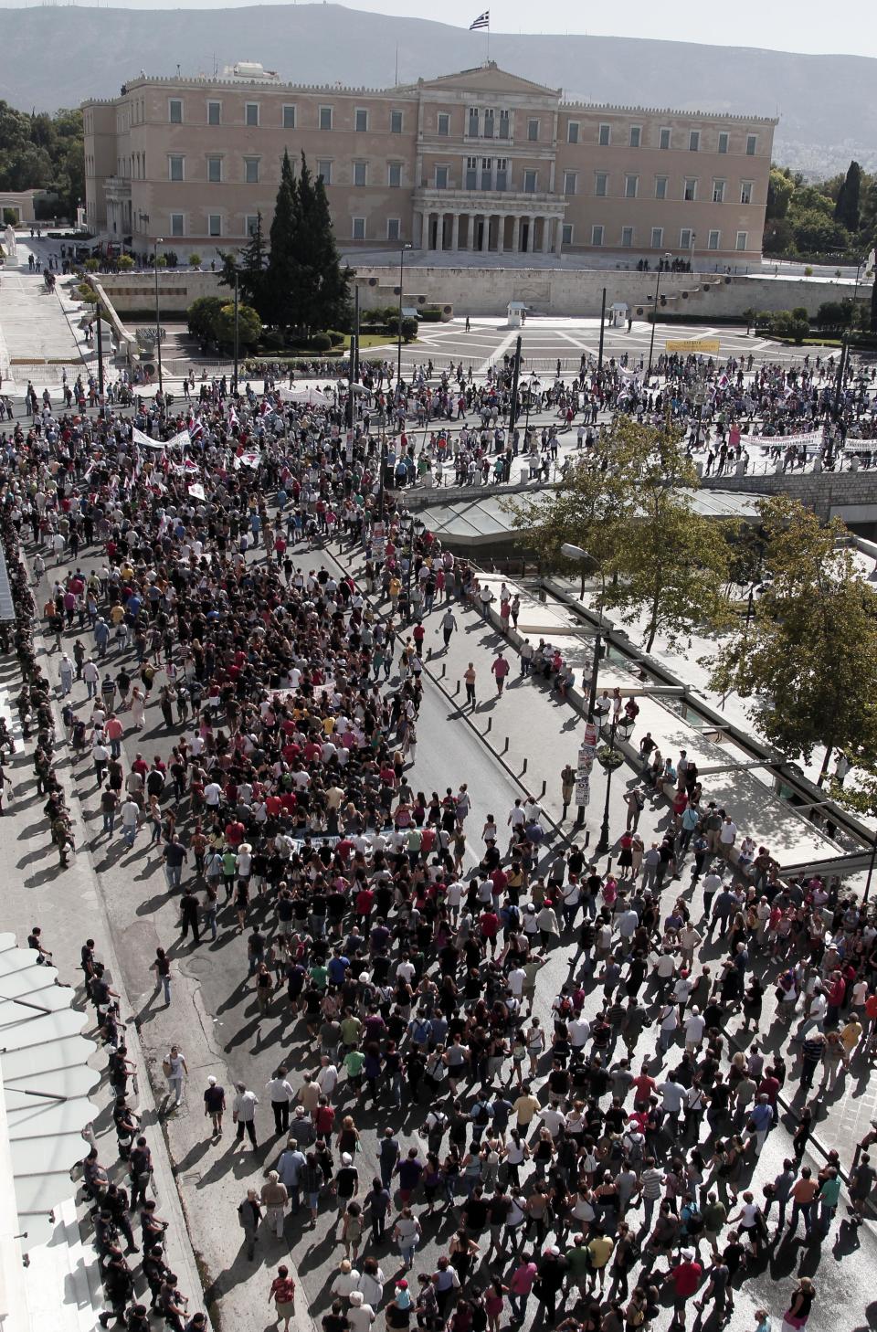 Protesters of the Greek Communist party affiliated unions march in front of the Greek Parliament in Athens Wednesday Sept. 26, 2012. Greek workers walked off the job Wednesday for the first general strike since the country's coalition government was formed in June, as the prime minister and finance minister hammered out a package of euros 11.5 billion ($14.87 billion) in spending cuts. (AP Photo/Dimitri Messinis)