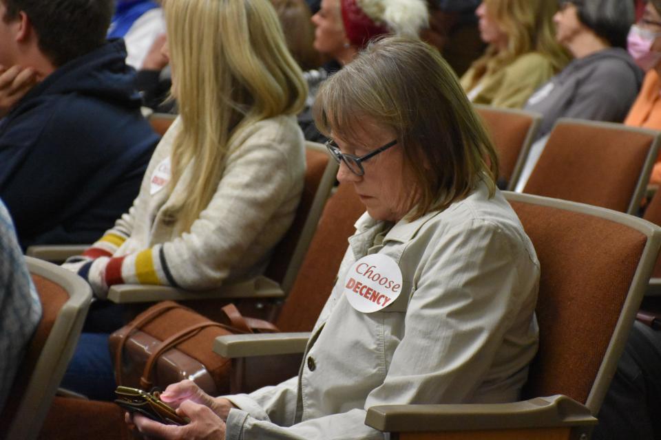 Audience member with a Choose Decency sticker at the Franklin Board of Aldermen meeting on March 28.