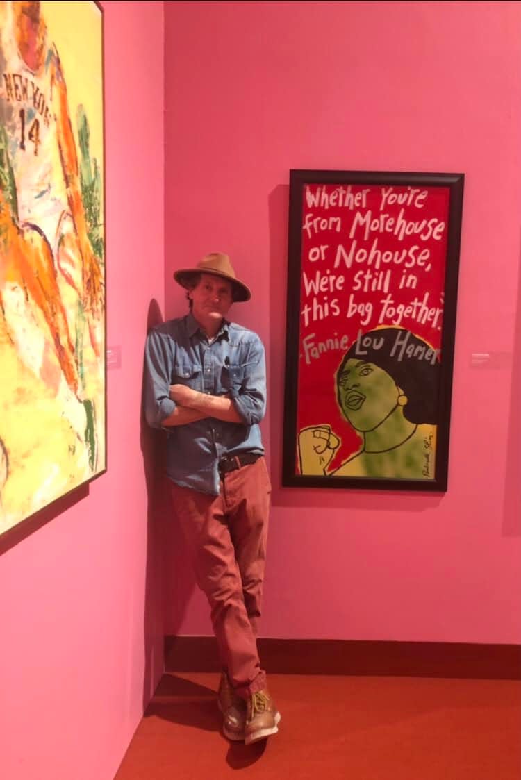Artist Scott "Panhandle Slim" Stanton poses next to his painting of civil rights leader Fannie Lou Hamer. The work was included in a Brooklyn Museum exhibition of art owned by director Spike Lee.