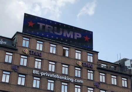 A digital billboard displays a sign reading "TRUMP" in Copenhagen