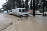 Vehicles are parked in a flooded street following heavy rainfall in Yalta