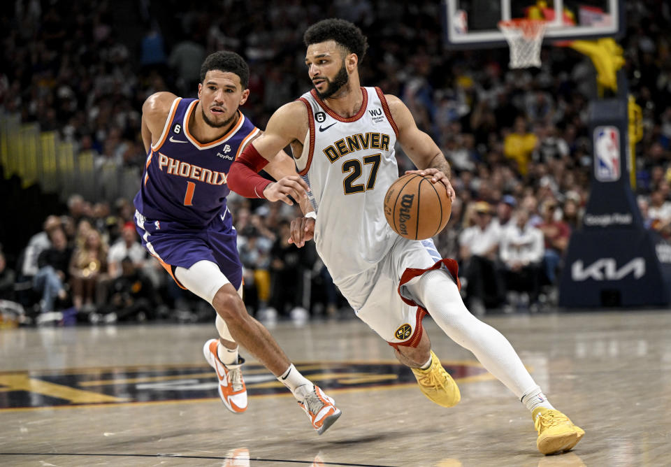 DENVER, CO - MAY 9: Jamal Murray (27) of the Denver Nuggets drives past Devin Booker (1) of the Phoenix Suns during the fourth quarter of the Nuggets' 118-102 win at Ball Arena in Denver on Tuesday, May 9, 2023. (Photo by AAron Ontiveroz/The Denver Post)