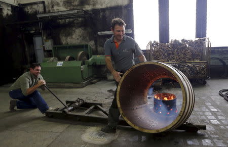 An employee works on an oak barrel in a workshop at the Hennessy factory in Cognac, southwestern France, November 5, 2015. REUTERS/Regis Duvignau