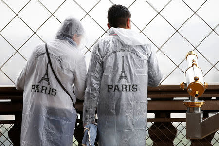 Tourists view the skyline from the Eiffel Tower during a rainy day in Paris, France, May 30, 2016. REUTERS/Charles Platiau