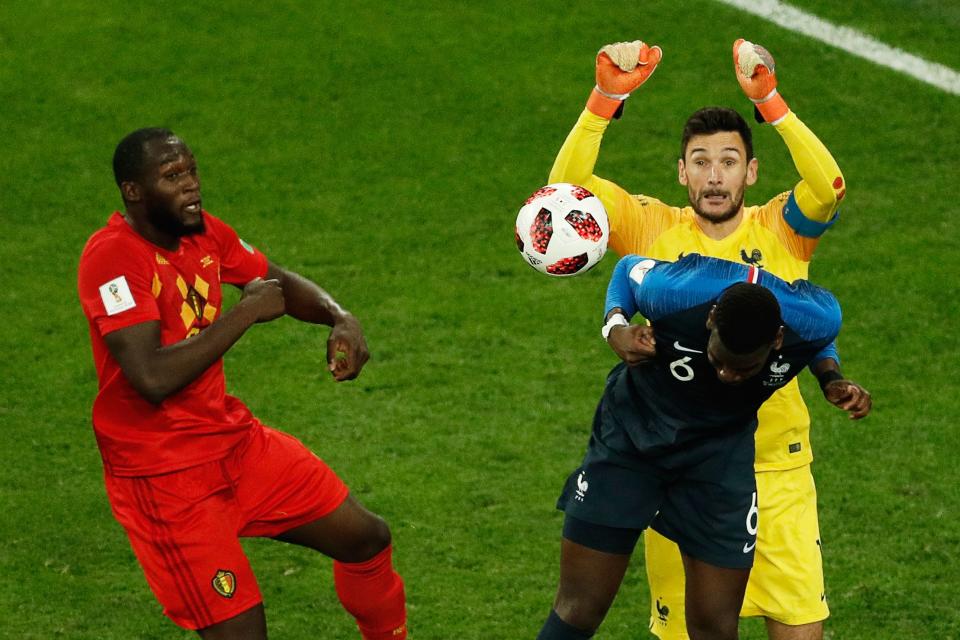 <p>France’s goalkeeper Hugo Lloris (rear R) jumps to catch the ball as he vies for it with Belgium’s forward Romelu Lukaku (L) next to France’s midfielder Paul Pogba (front R) during the Russia 2018 World Cup semi-final football match between France and Belgium at the Saint Petersburg Stadium in Saint Petersburg on July 10, 2018. (Photo by Adrian DENNIS / AFP) </p>