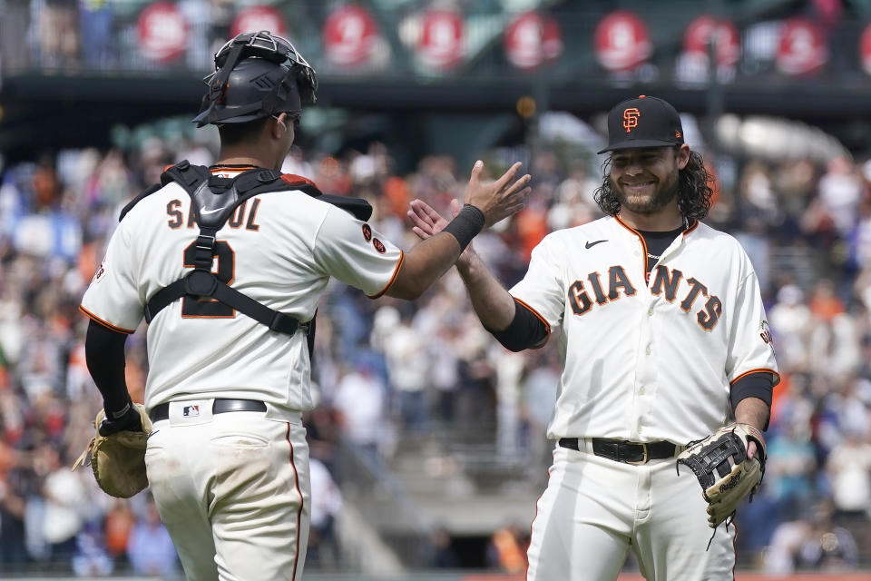 San Francisco Giants catcher Blake Sabol, left, celebrates with position player Brandon Crawford, who pitched the ninth inning, after the Giants defeated the Chicago Cubs in a baseball game in San Francisco, Sunday, June 11, 2023. (AP Photo/Jeff Chiu)