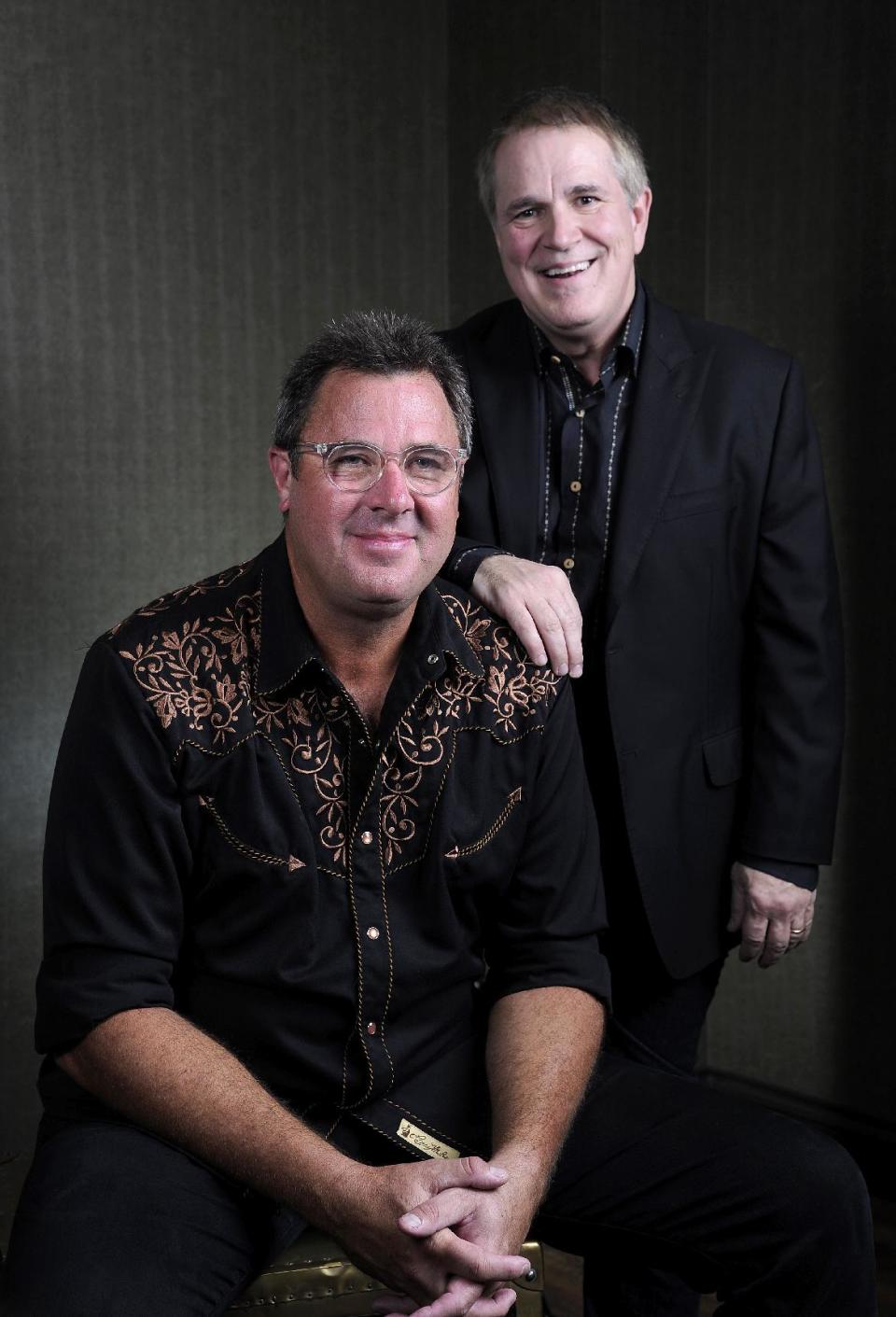 This Saturday, July 27, 2013 photo shows Vince Gill, left, and Paul Franklin posing at the Grand Ole Opry in Nashville, Tenn. Gill and Franklin released their latest album "Bakersfield," on July 30. (Photo by Donn Jones/Invision/AP)