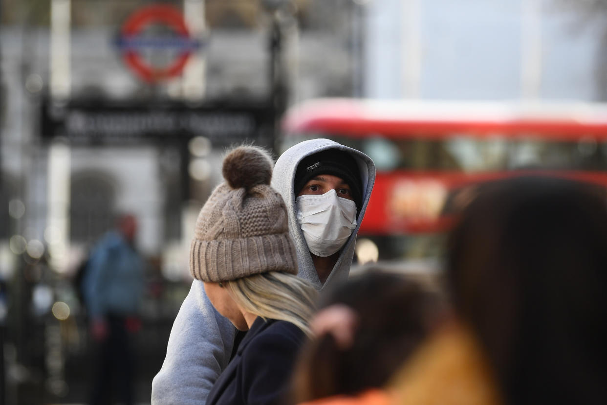 A man at a bust stop in Whitehall, London, wearing a protective facemask on the day that Health Secretary Matt Hancock said that the number of people diagnosed with coronavirus in the UK has risen to 51.