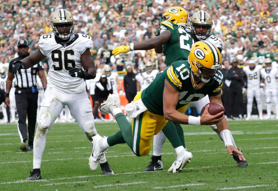 Green Bay Packers quarterback Jordan Love (10) dives for a touchdown against the New Orleans Saints in the fourth quarter during their football game Sunday, September 24, 2023, at Lambeau Field in Green Bay.