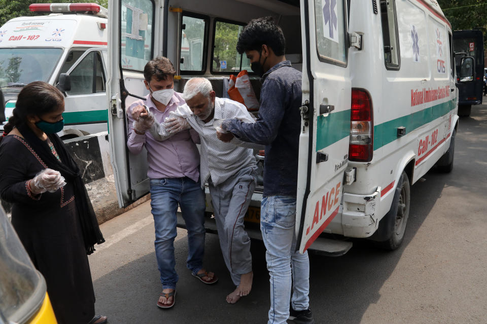 A senior citizen is being helped by his relatives after being discharged outside Guru Tech Bahuder Hospital in New Delhi. Source: Getty Images