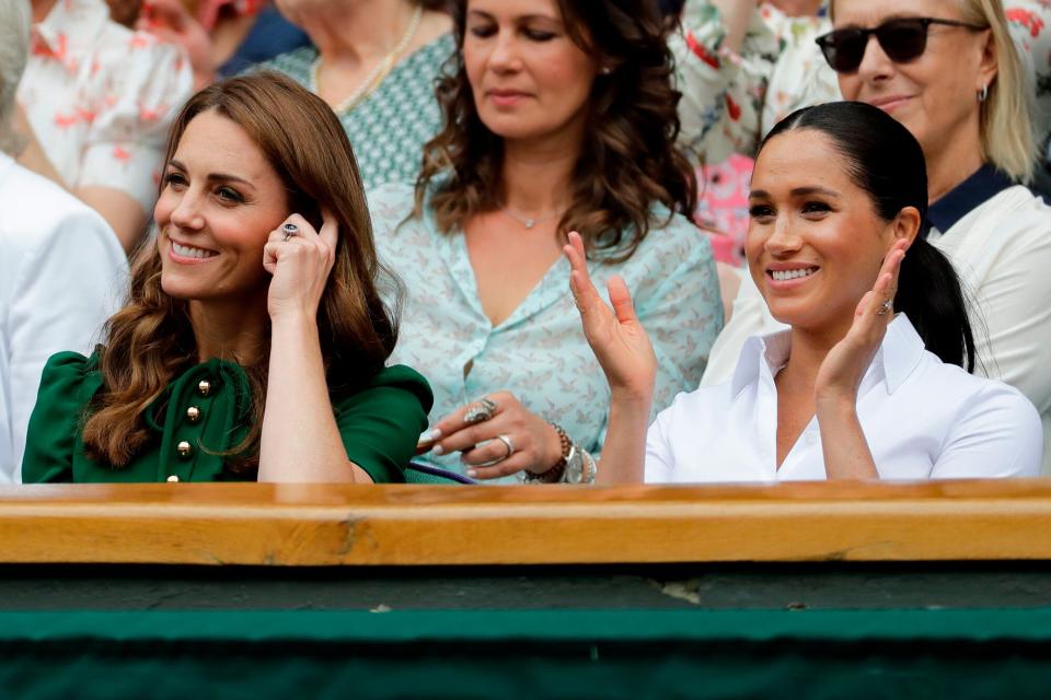 Britain's Catherine (L), Duchess of Cambridge and Britain's Meghan, Duchess of Sussex, watch Romania's Simona Halep playing US player Serena Williams