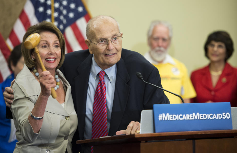 House Minority Leader Nancy Pelosi (D-Calif.) and former Rep. John Dingell celebrate the 50th anniversary of Medicare and Medicaid on July 29, 2015. Pelosi is holding the gavel that Dingell used when he presided over the vote to pass Medicare in 1965 and that&nbsp;she used during the passage of the Affordable Care Act. (Photo: Bill Clark/CQ Roll Call via Getty Images)