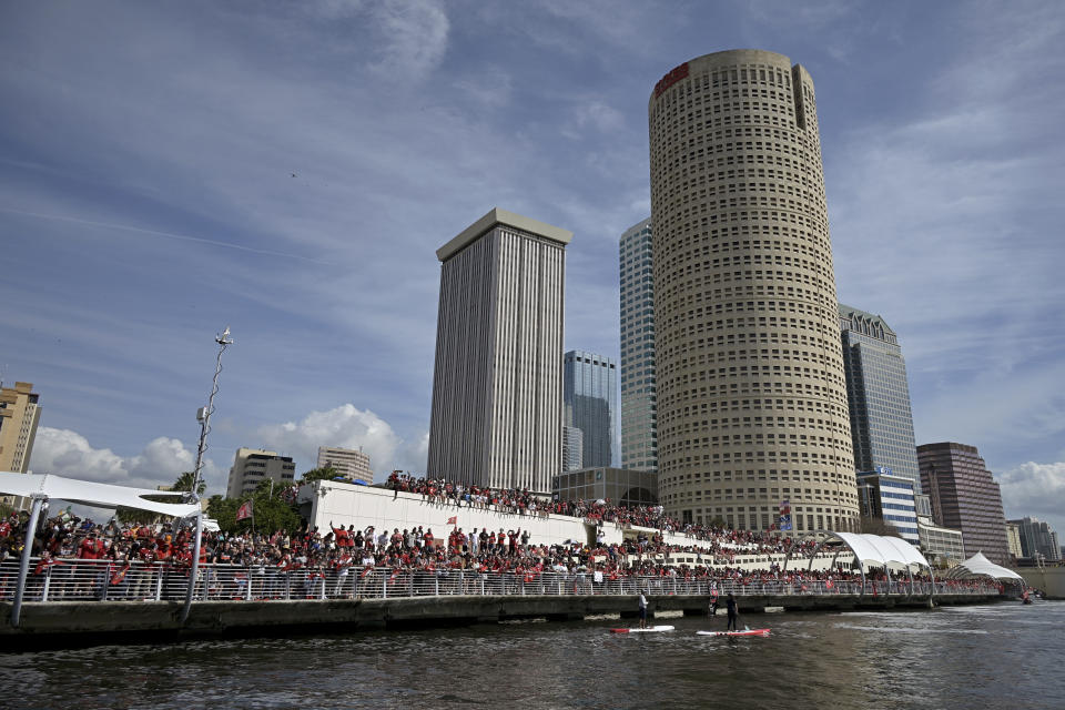 Fans watch the NFL football Tampa Bay Buccaneers celebrate their Super Bowl 55 victory over the Kansas City Chiefs with a boat parade in Tampa, Fla., Wednesday, Feb. 10, 2021. (AP Photo/Phelan Ebenhack)