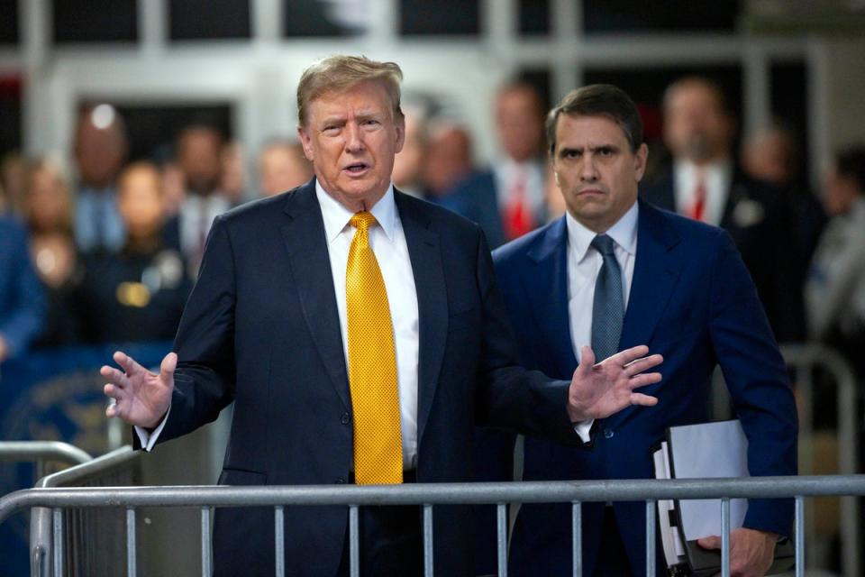 Former President Donald Trump speaks alongside his attorney Todd Blanche outside the courtroom in Manhattan Criminal Court on May 21 (AP)