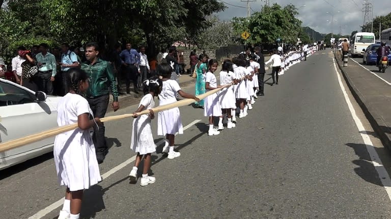 About 250 students of a state-owned school carried the train of the saree worn by the bride, local media reported