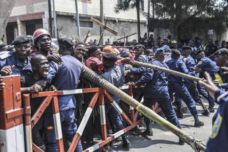 Demonstrators are stopped by police as they try to march towards the border with Rwanda, in Goma, Democratic Republic of Congo, Wednesday June 15, 2022. Congo's military is accusing Rwanda of "no less than an invasion" after a rebel group captured a key town in eastern Congo. The military confirmed late Monday that Bunagana had fallen into rebel hands earlier in the morning. (AP Photo/Moses Sawasawa)