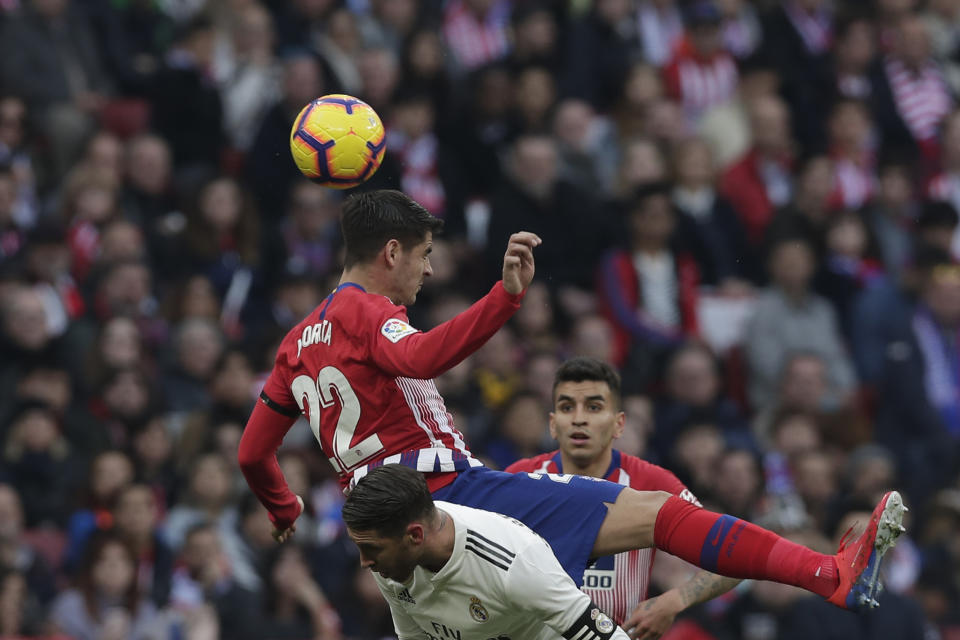 Atletico Madrid's Alvaro Morata jumps for the ball during a Spanish La Liga soccer match between Atletico Madrid and Real Madrid at the Metropolitano stadium in Madrid, Spain, Saturday, Feb. 9, 2019. (AP Photo/Manu Fernandez)