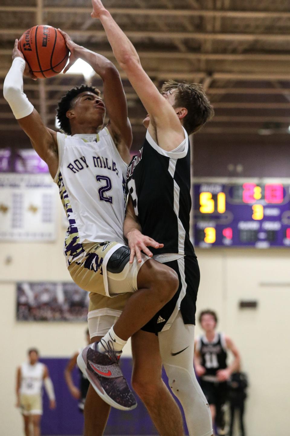 Londons Preston Cazalas attempts to block a basket by Miller's Damare Lister during the game at Miller High School on Friday, Dec. 16, 2022, in Corpus Christi, Texas.