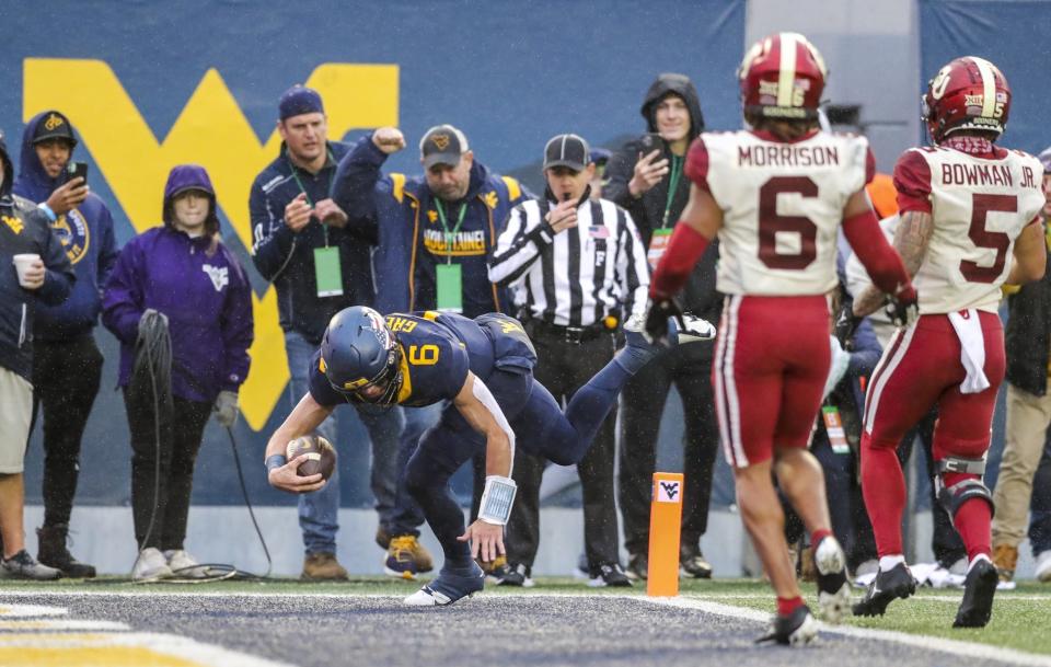 Nov 12, 2022; Morgantown, West Virginia, USA; West Virginia Mountaineers quarterback Garrett Greene (6) dives for a touchdown during the fourth quarter against the Oklahoma Sooners at Mountaineer Field at Milan Puskar Stadium. Mandatory Credit: Ben Queen-USA TODAY Sports