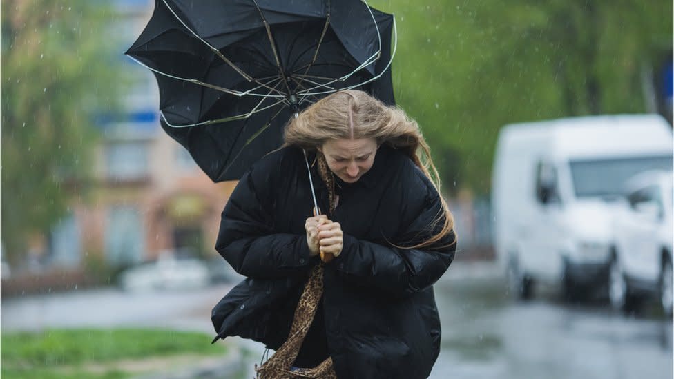 Blonde woman under umbrella