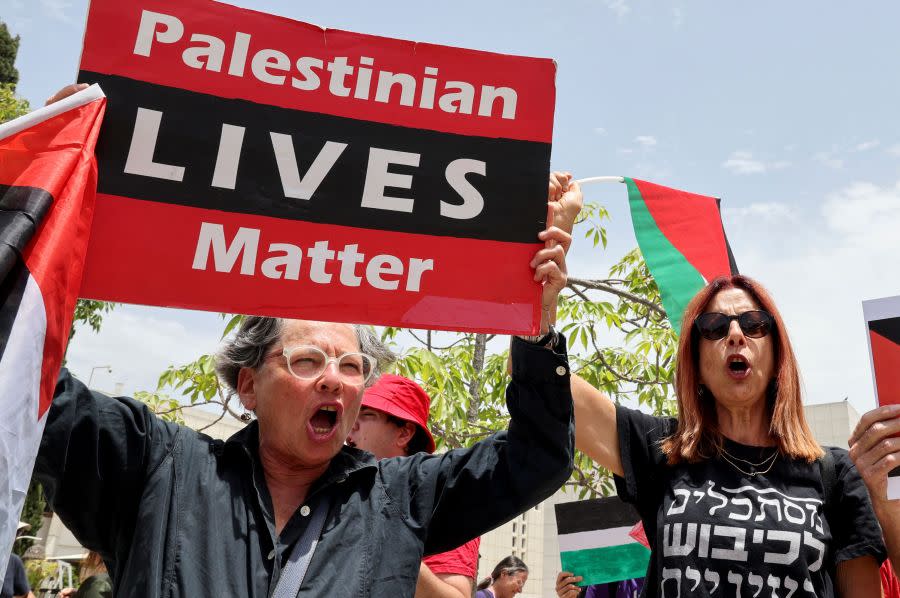 Arab-Israeli students and Israeli left-wing activists lift flags and placards during a protest against a new law bill bolstering restrictions on raising the Palestinian flag, at the Tel Aviv University campus in the eponymous coastal city, on May 28, 2023. The proposed legislation, which would prohibit flying the flag of a “hostile entity”, is being promoted by a lawmaker from the extreme-right Jewish Power party, which is a partner in the coalition of Prime Minister Benjamin Netanyahu. (Photo by JACK GUEZ / AFP) (Photo by JACK GUEZ/AFP via Getty Images)