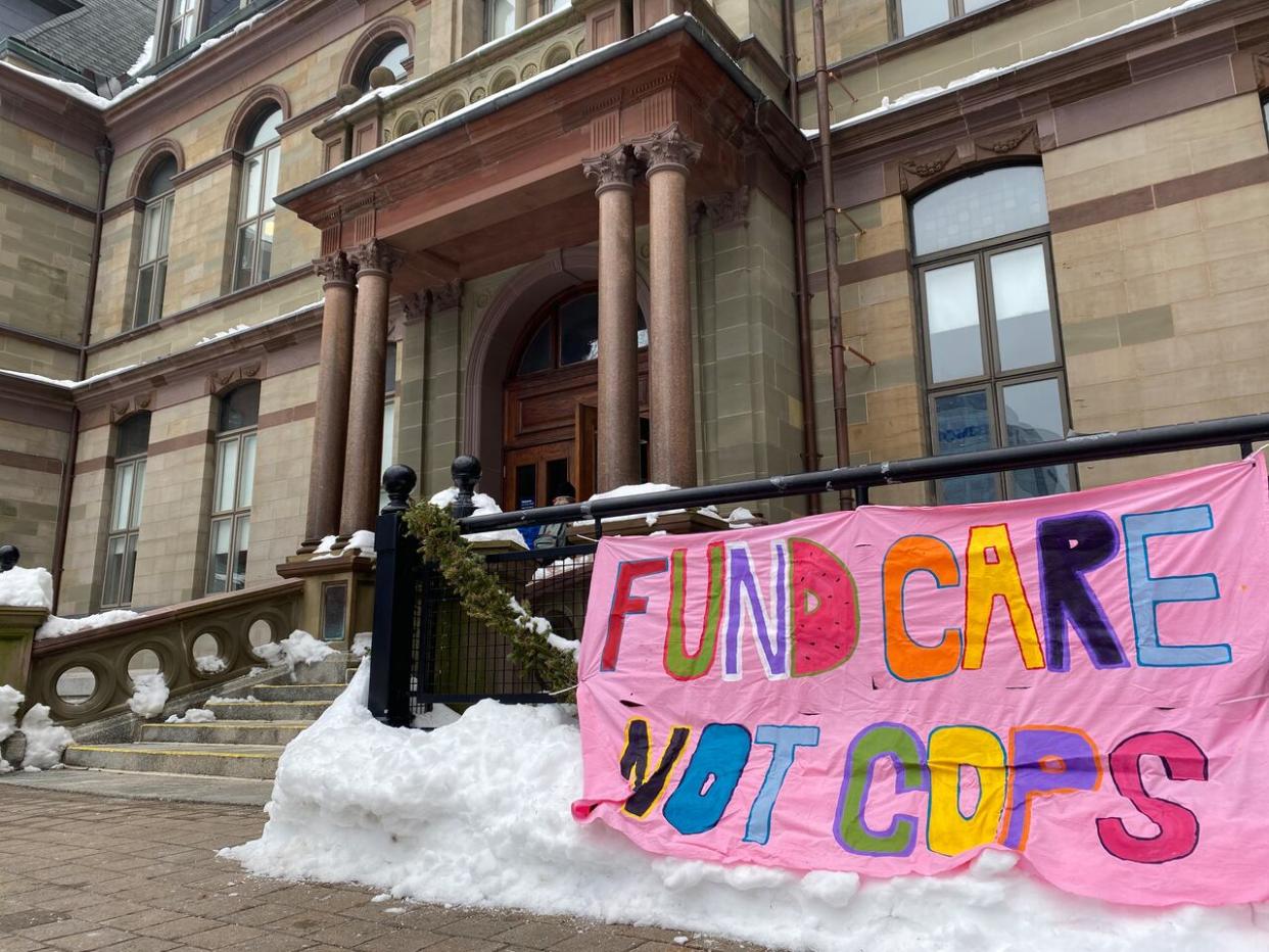 A sign outside Halifax's city hall in February. The municipality is considering using civilian-led crisis teams as an alternative to sending police to mental health calls. (Haley Ryan/CBC - image credit)