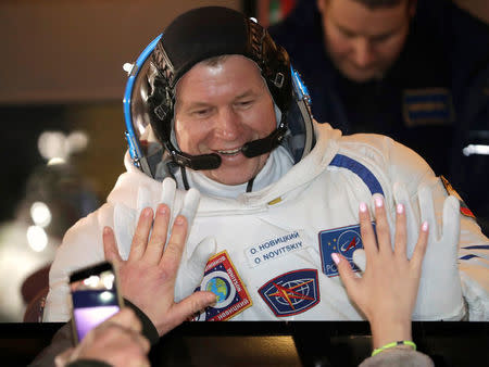 The International Space Station (ISS) crew member, Oleg Novitskiy of Russia gestures from a bus prior to the launch of Soyuz MS-3 space ship at Baikonur cosmodrome, Kazakhstan, November 17, 2016. REUTERS/Dmitri Lovetsky