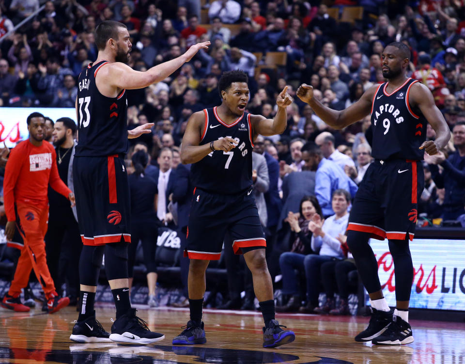 TORONTO, ON - FEBRUARY 11:  Marc Gasol #33 and Serge Ibaka #9 of the Toronto Raptors congratulate Kyle Lowry #7 during the first half of an NBA game against the Brooklyn Nets at Scotiabank Arena on February 11, 2019 in Toronto, Canada.  NOTE TO USER: User expressly acknowledges and agrees that, by downloading and or using this photograph, User is consenting to the terms and conditions of the Getty Images License Agreement.  (Photo by Vaughn Ridley/Getty Images)