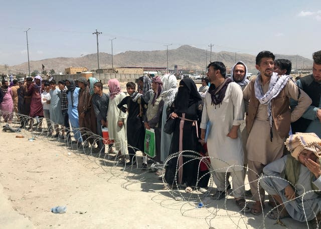 Hundreds of people gather outside the international airport in Kabul, Afghanistan