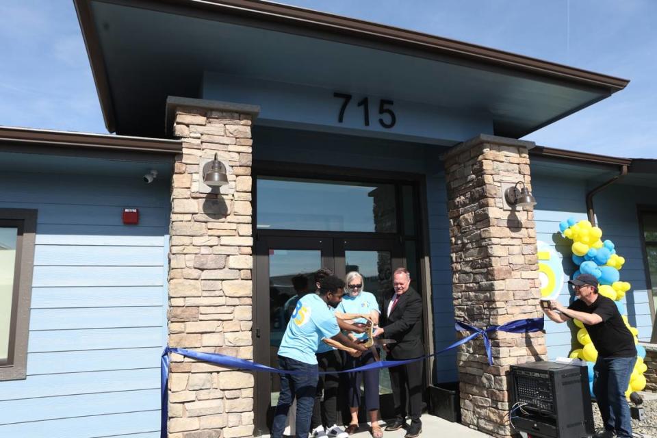 B5 staff, executive director Theresa Roosendaal and Sen. Matt Boehnke, R-Kennewick, stand at the entrance of the B5 Community Learning Center.