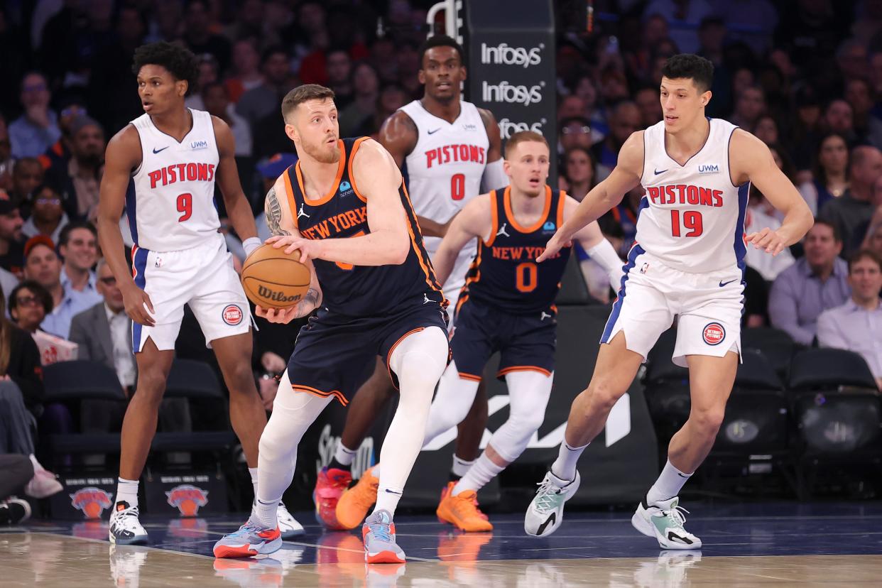 New York Knicks center Isaiah Hartenstein looks to pass the ball against Detroit Pistons forward Ausar Thompson and center Jalen Duren and forward Simone Fontecchio during the first quarter at Madison Square Garden on Monday, Feb 26, 2024 in New York, New York.