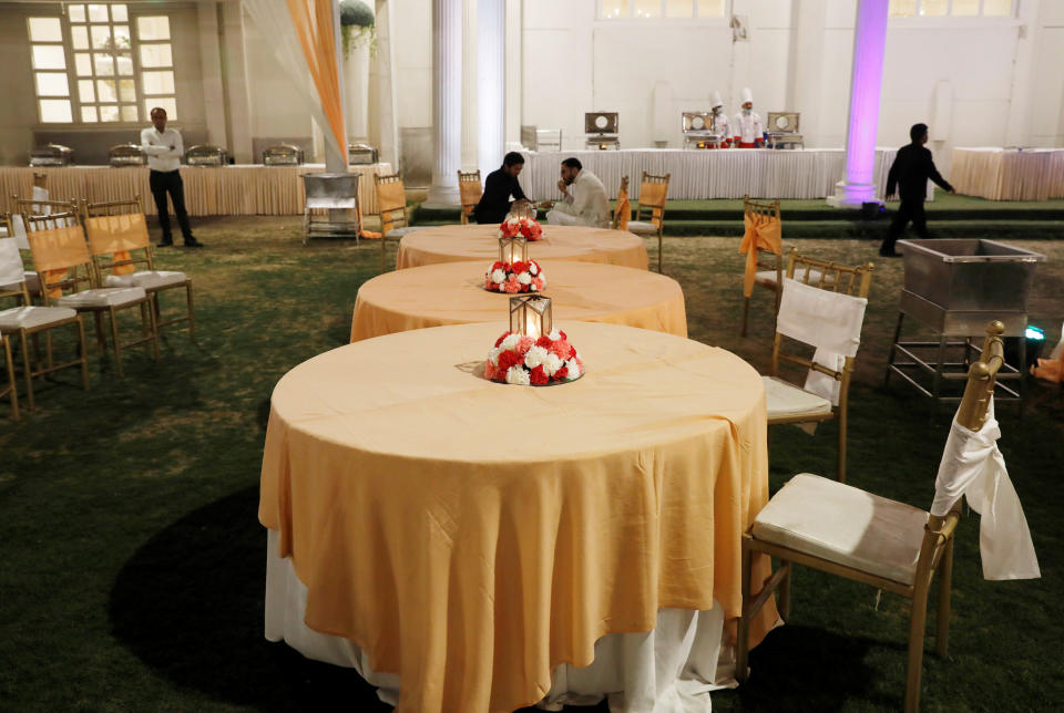 Guests eat food at a wedding ceremony amidst an outbreak of the coronavirus disease (COVID-19) in New Delhi, India, March 21, 2020. Picture taken on March 21, 2020. REUTERS/Adnan Abidi