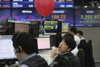A currency trader watches monitors at the foreign exchange dealing room of the KEB Hana Bank headquarters in Seoul, South Korea, Thursday, Jan. 23, 2020. Asian shares are mostly higher as health authorities around the world move to monitor and contain a deadly virus outbreak in China and keep it from spreading globally. (AP Photo/Ahn Young-joon)