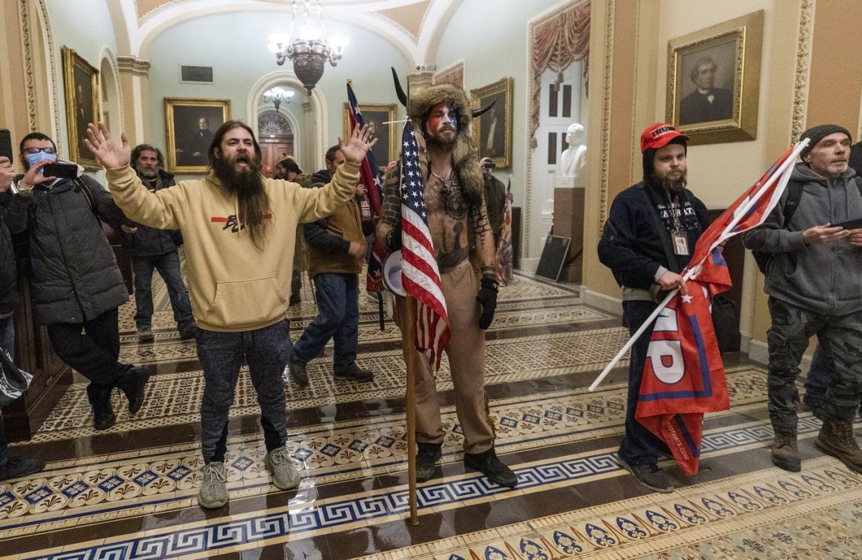 <span class="caption">The man on the right wearing the Trump hat was identified by his badge as an employee of Navistar Direct Marketing, which fired him.</span> <span class="attribution"><a class="link " href="https://newsroom.ap.org/detail/NotRealNews/87c8771b339746edafb3b49f74b68dc0/photo?Query=jake&mediaType=photo&sortBy=arrivaldatetime:desc&dateRange=Anytime&totalCount=37825&currentItemNo=8" rel="nofollow noopener" target="_blank" data-ylk="slk:AP Photo/Manuel Balce Ceneta;elm:context_link;itc:0;sec:content-canvas">AP Photo/Manuel Balce Ceneta</a></span>