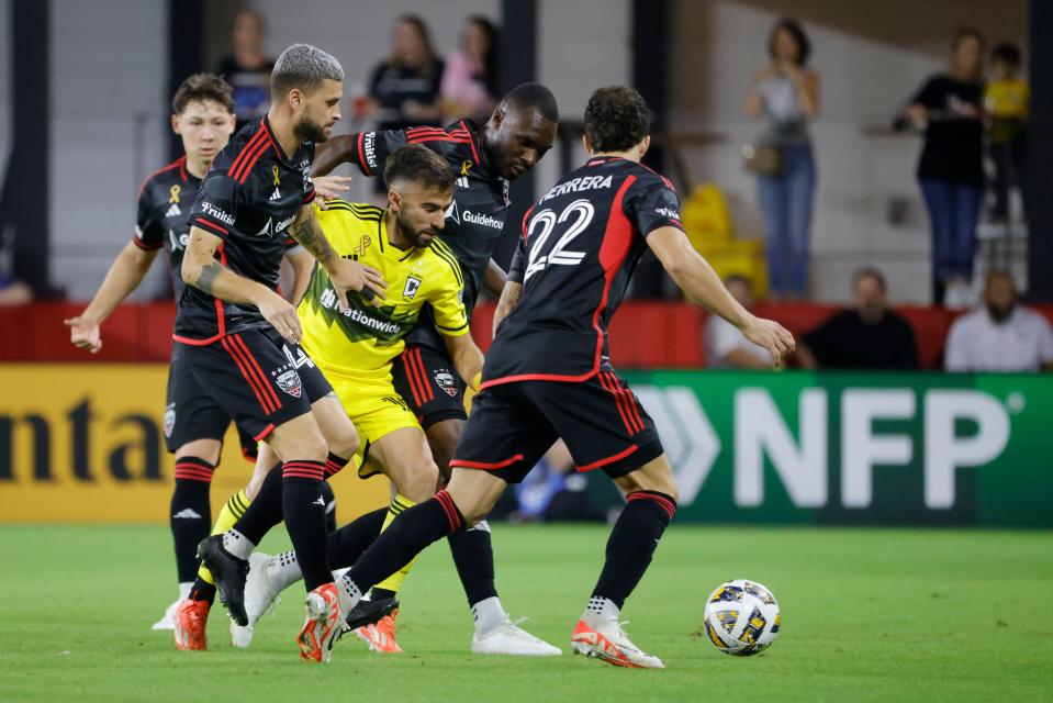 Sep 28, 2024; Washington D.C., USA; Crew forward Diego Rossi battles for the ball with D.C. United defender Aaron Herrera (22), forward Christian Benteke (20) and midfielder Mateusz Klich (43) during first half at Audi Field. Mandatory Credit: Amber Searls-Imagn Images