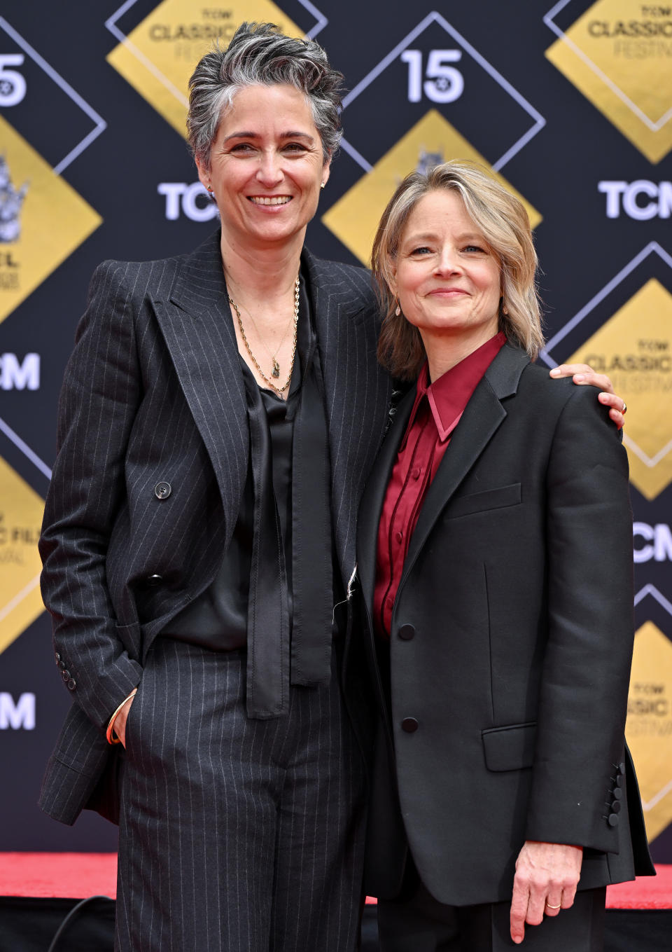 Jodie Foster and Alexandra Hedison pose together in tailored suits at the TCM Classic Film Festival red carpet