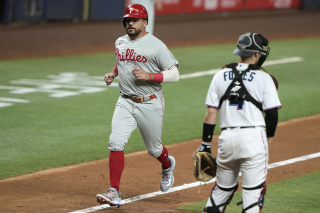 Miami Marlins' Jean Segura, left, is out at the plate on a throw from  Philadelphia Phillies second baseman Bryson Stott to catcher J.T. Realmuto,  right, during the eighth inning of a baseball