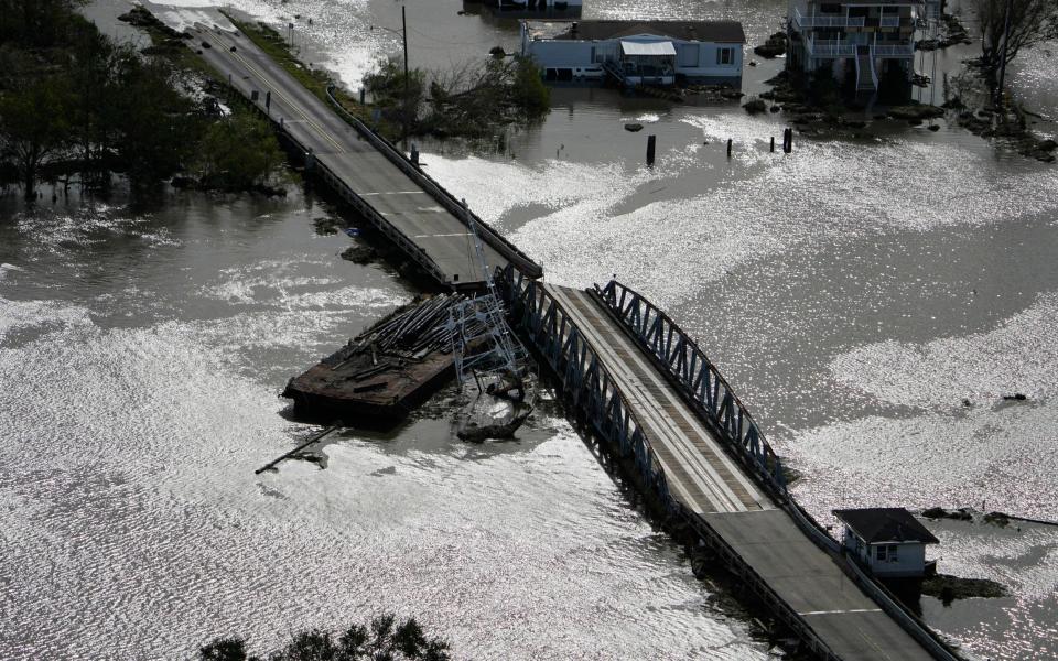 A barge damages a bridge that divides Lafitte, La., and Jean Lafitte, in the aftermath of Hurricane Ida