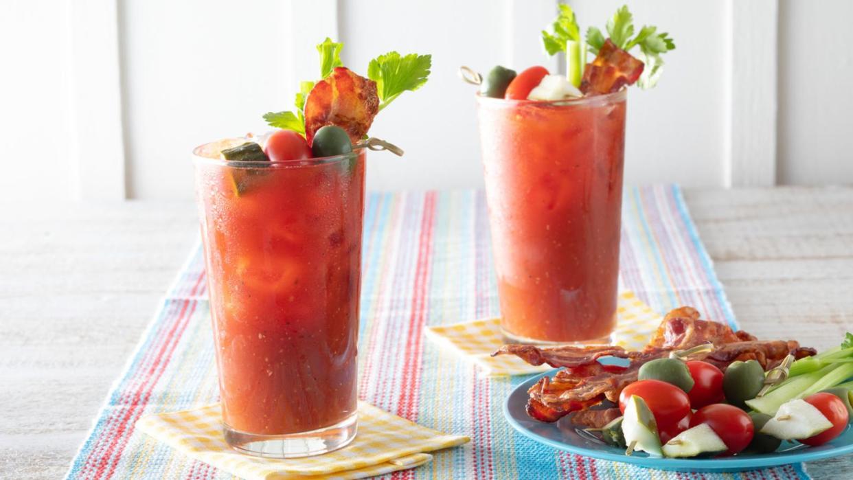 classic bloody mary two glasses with garnishes on plate